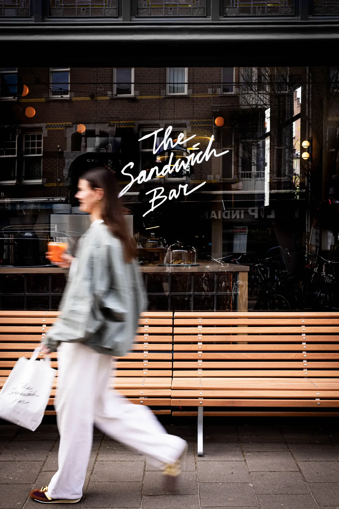 Walking past The Sandwich Bar storefront
